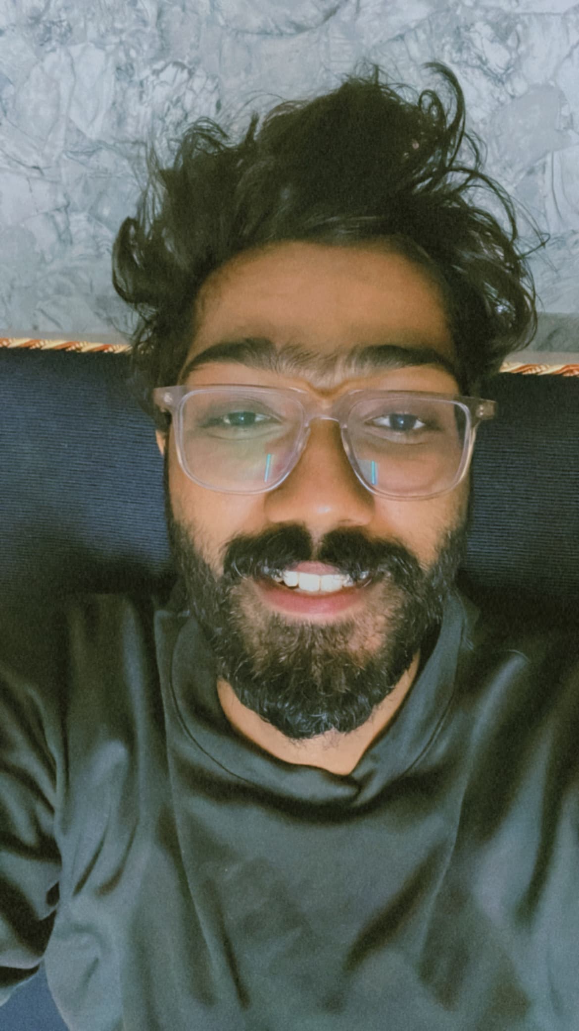 Me smiling in my bed with my laptop